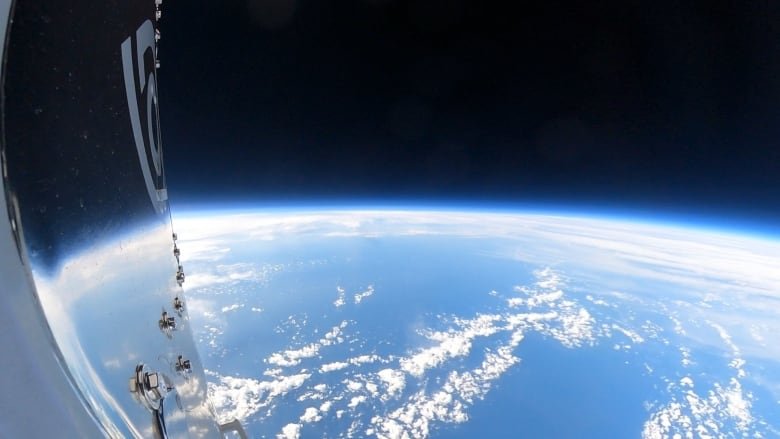 Our planet as seen from the altitude that the hot air balloon company reaches which shows the thin blue haze enveloping Earth with the reflection of it on the left hand side of the test capsule.