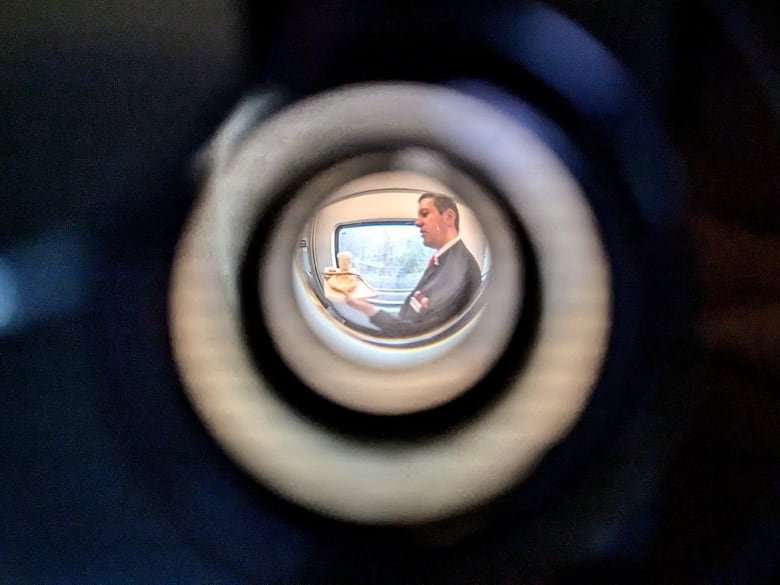 A train server is seen through a keyhole.