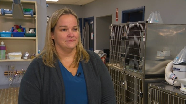 A woman stands in a vet clinic