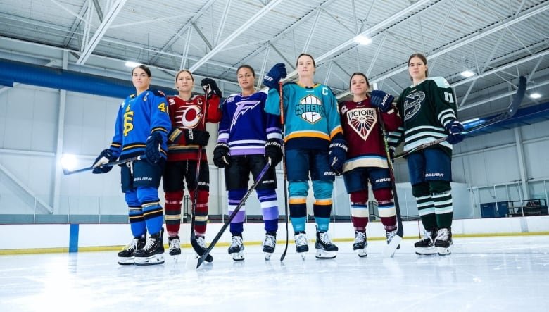 Six women's hockey players are shown in their new team uniforms.