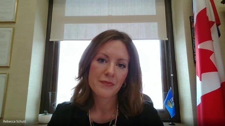 A woman takes part in a Google Meet call at her desk.