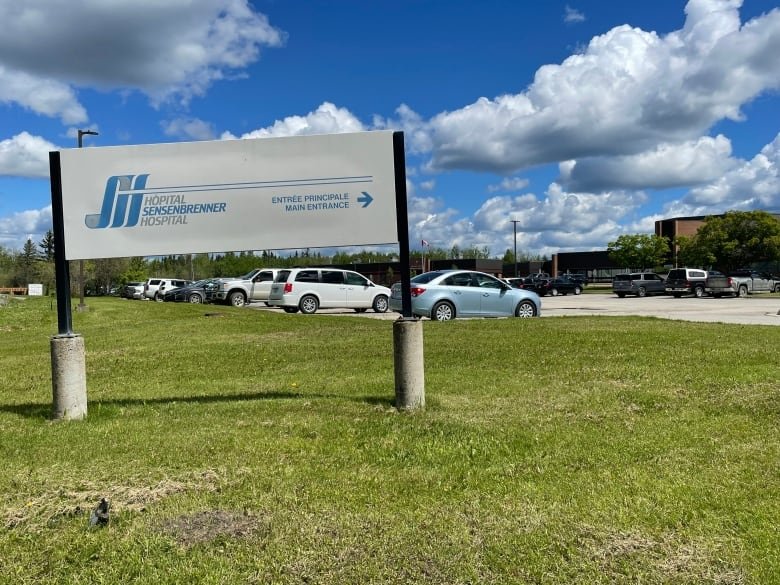 The hospital sign with a parking lot in the background