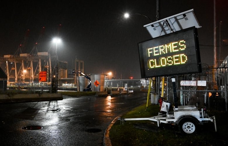 A sign reading "closed" is shown next to the entrance to a terminal at the Port of Montreal in Montreal, Sunday, Nov. 10, 2024, where a lock out of dock workers has been declared by the employer.