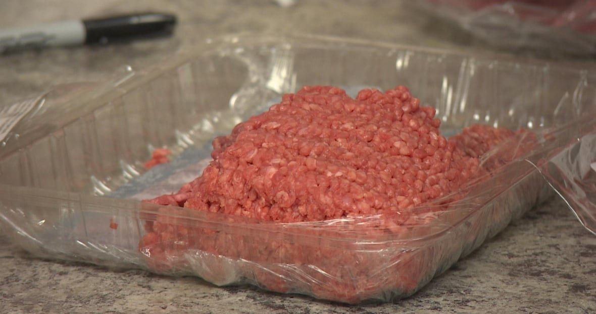 A thick plastic packaging tray containing a portion of ground beef.