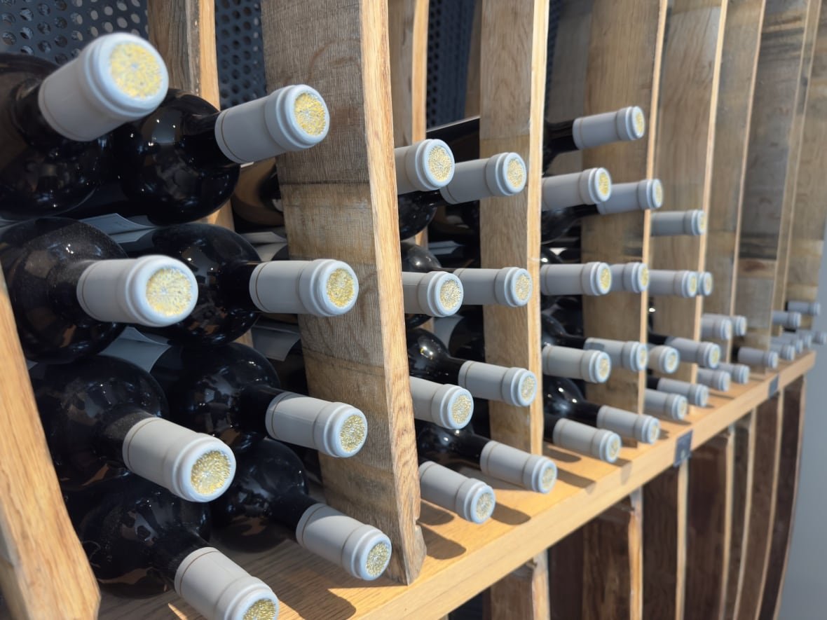 bc-wine-4 Bottles of wine are stacked on a store shelf.
