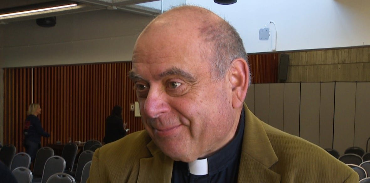 bill-strong Man in black shirt with a clerical collar