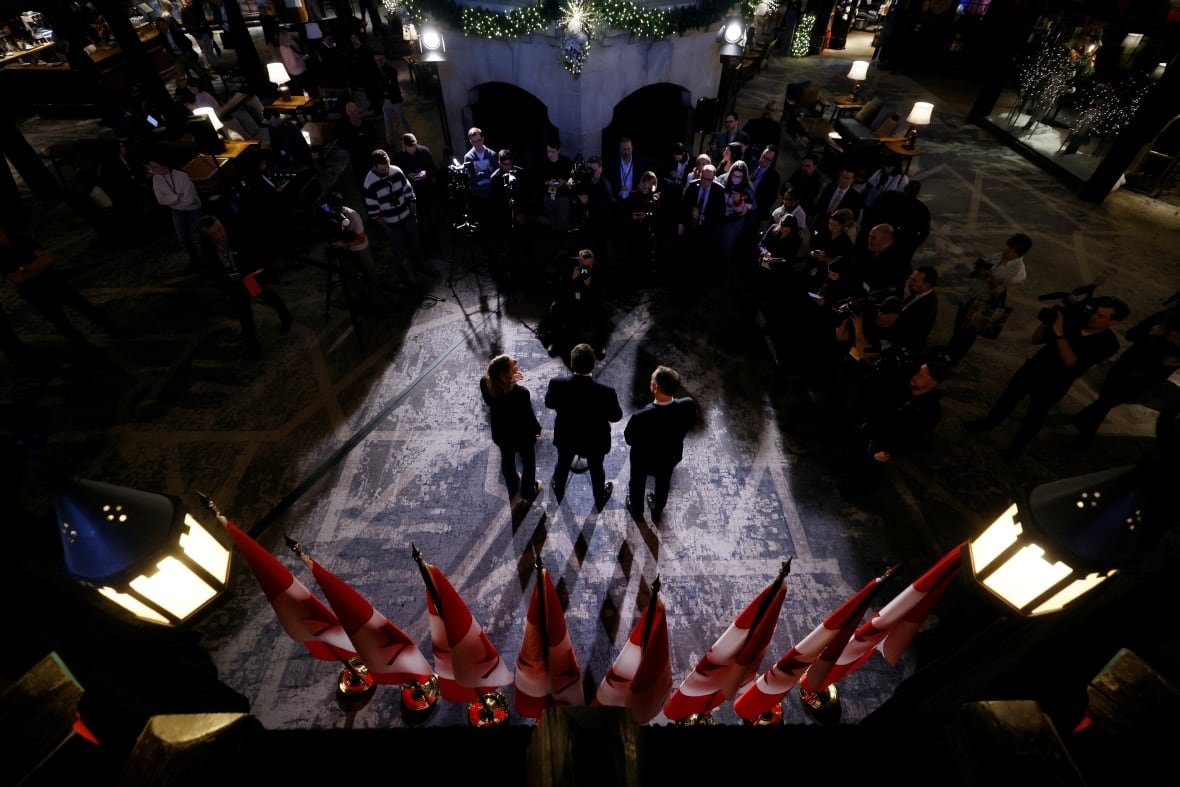 canada-politics-1 Three people seen from above near flags.