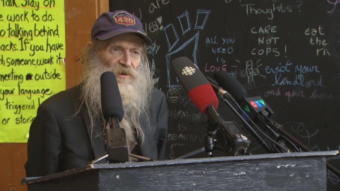 dave-hamm A bearded man speaks at a podium.