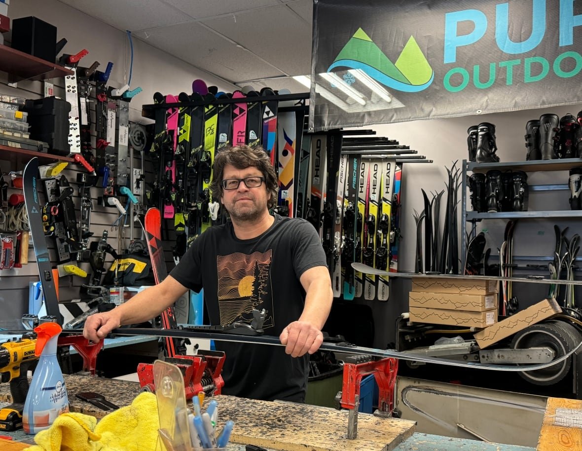 jean-francois-bussieres-pure-outdoors The owner of an outdoor gear shop repairs skis.