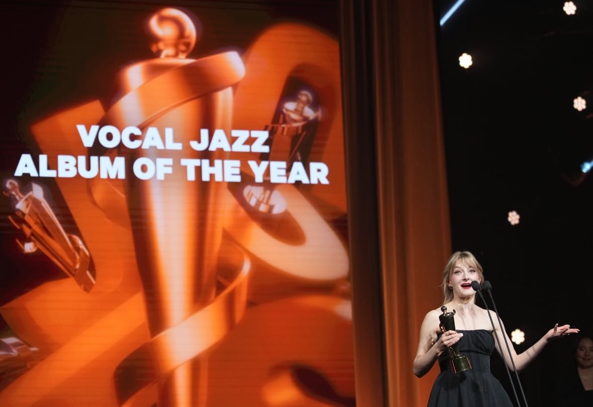 music-juno-awards-20250329-7 A person holds an award while making a speech on stage.