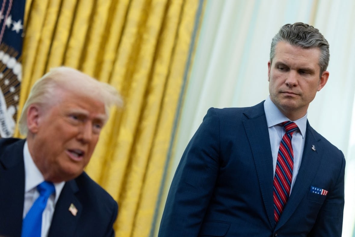 usa-trump-houthis-intel-2 U.S. Defense Secretary Pete Hegseth stands by U.S. President Donald Trump, in the Oval Office at the White House, in Washington, D.C., U.S., March 21, 2025.