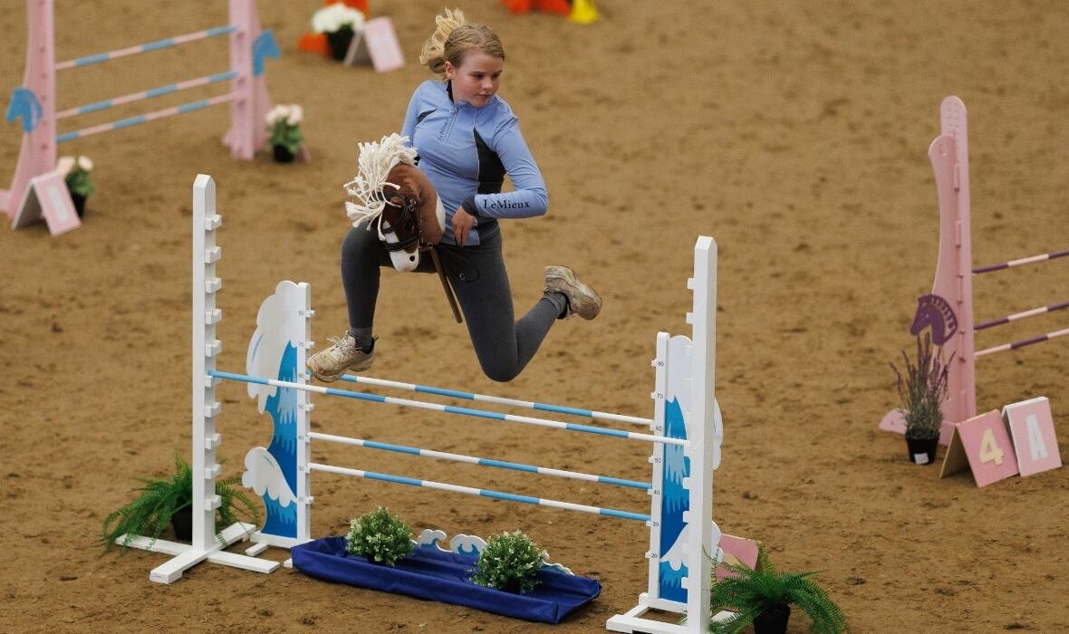 A child plays in a hobby horse competition. Young equine enthusiasts take advantage of its inclusivity, and enjoy the physical activity required, creativity and freedom of expression. The sport has also been found to help young people suffering with autism and ADHD, giving them a chance to connect with other young people with a love of horses.