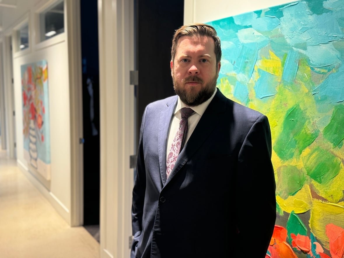 Edmonton defence attorney Austin Corbett poses in his office.