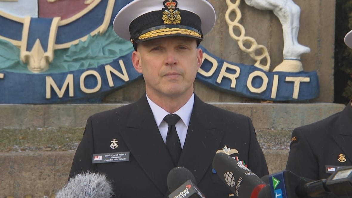 commodore-jacob-french-commander-of-canadian-fleet-atlantic Man in naval uniform stands in front of monument