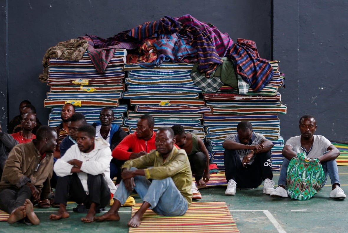 congo-security-rwanda Men sitting down indoors.