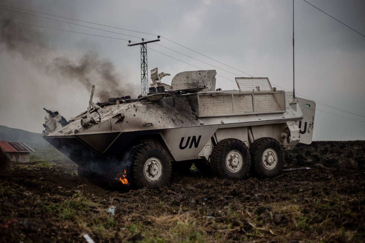 congo An armoured personnel carrier burns on the side of the road.