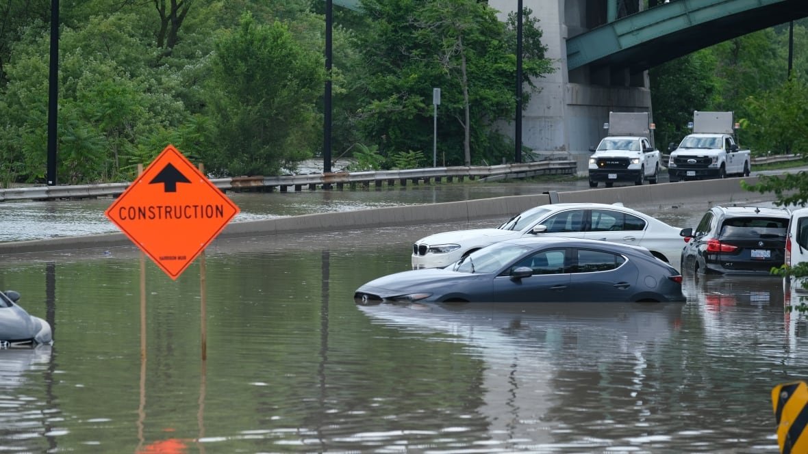 dvp-flooding-cars-aftermath-rail-lines Photograph showing submerged cars on the flooded DVP.