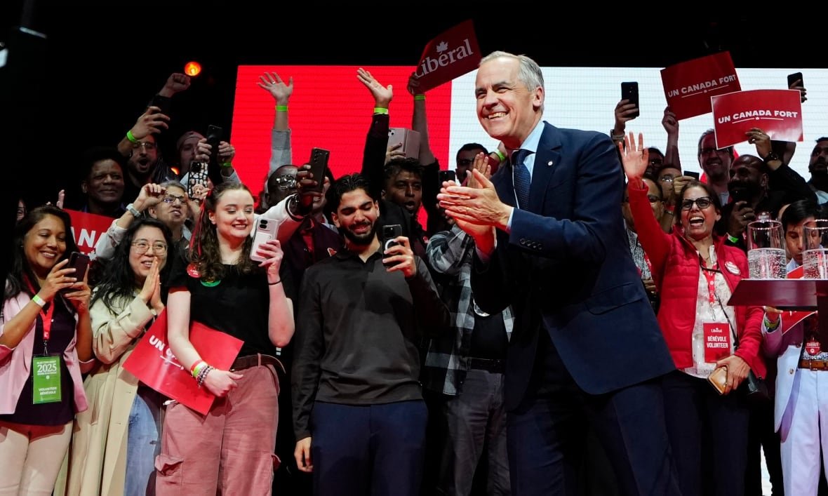 fedelxn-liberals-20250429 A person on stage clapping his hands.