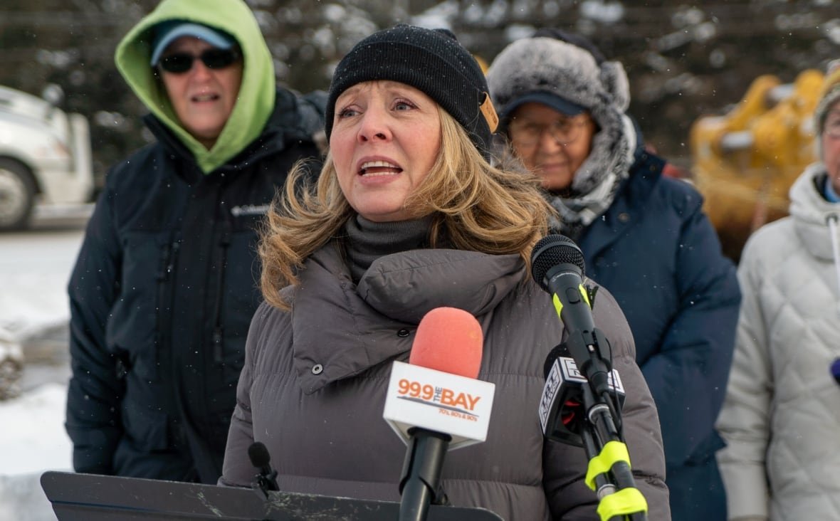 marit-stiles Outdoor photo of Marit Stiles in winter coat, speaking at a podium