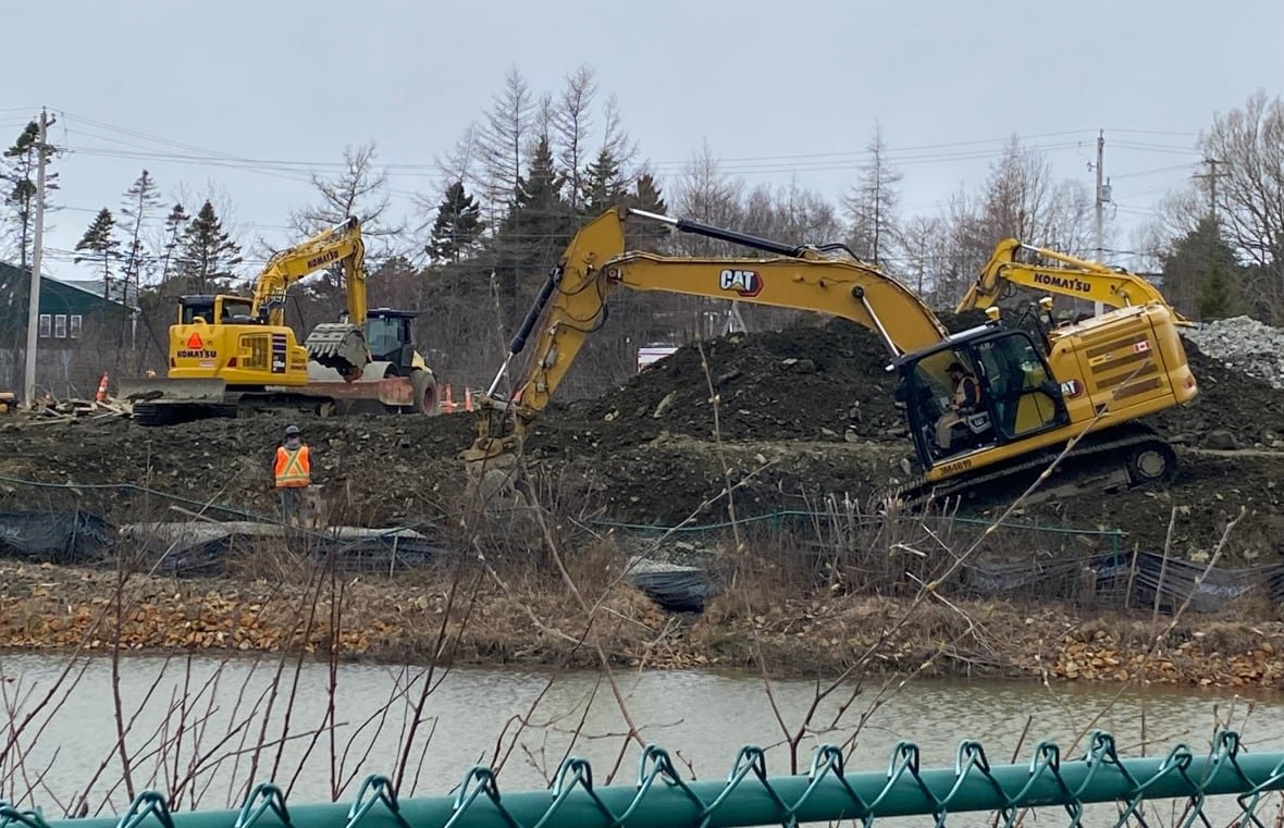 new-shoreham-village-1 Construction equipment digs around a pond.
