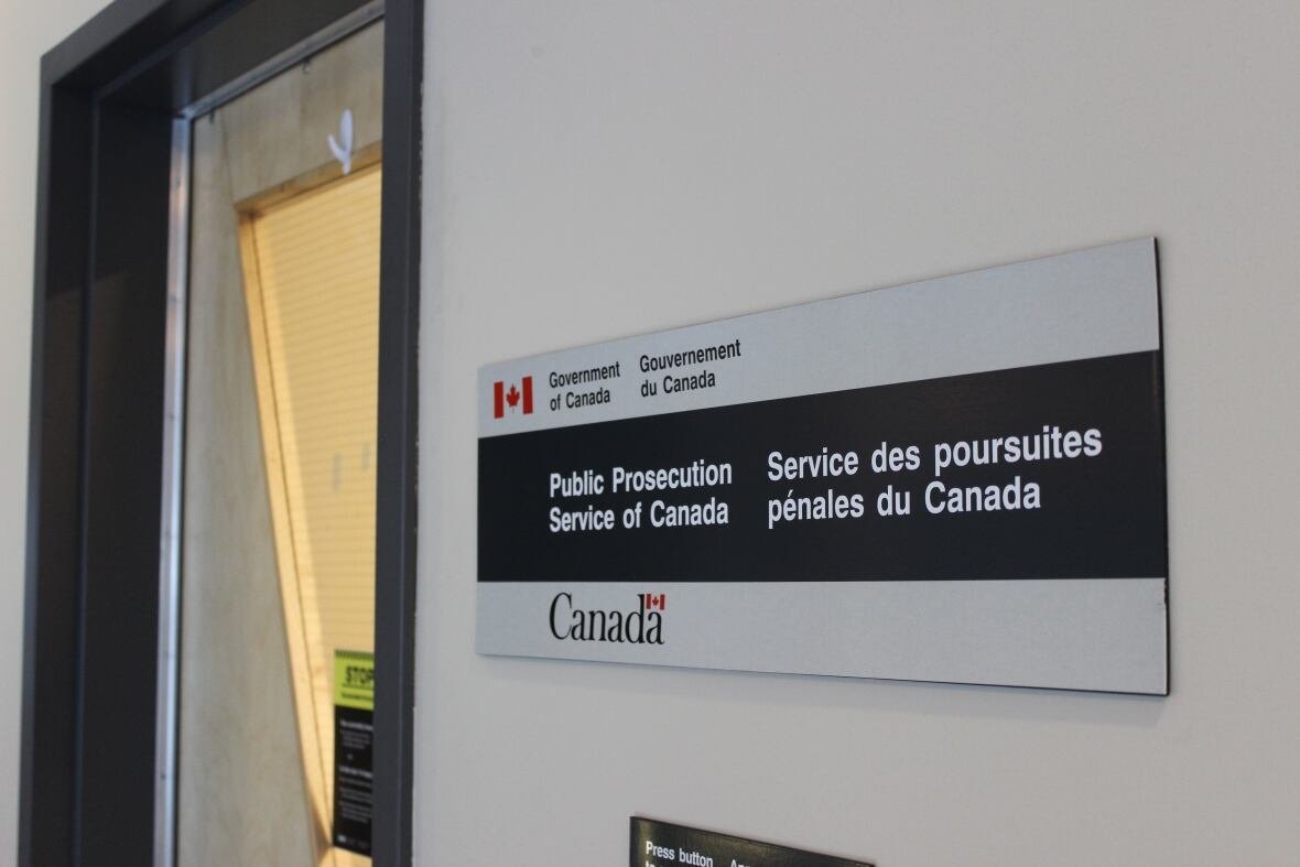 public-prosecution-service-of-canada-s-yellowknife-office A sign next to a door inside a building.