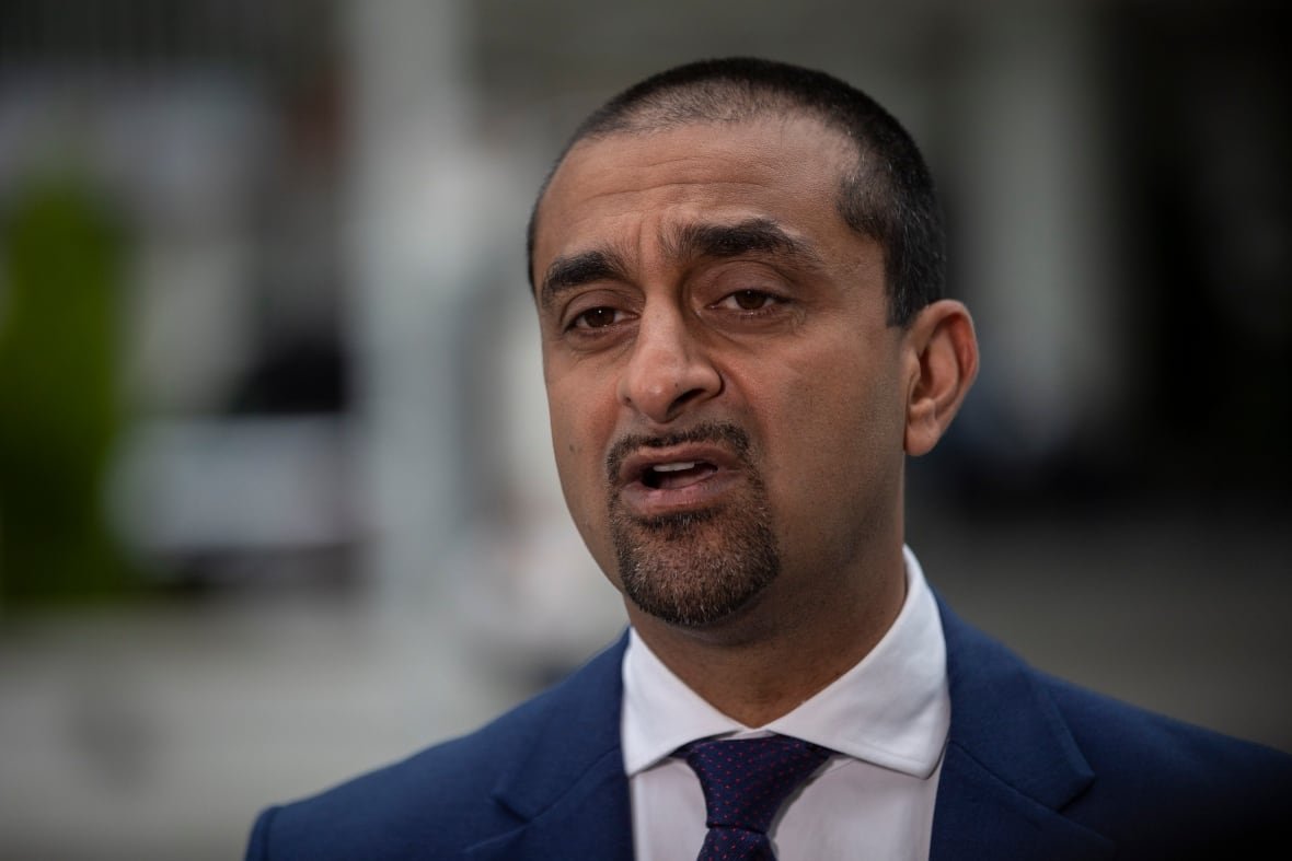 ravi-kahlon A man with short black hair wearing a suit speaks in a close-up photo.