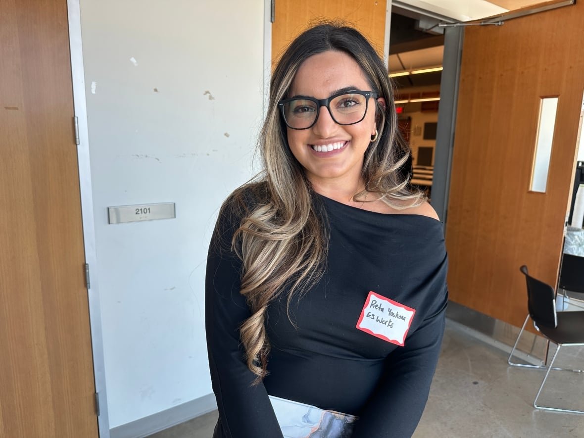 reta-youhana-e3-works A woman in a black top and glasses smiles