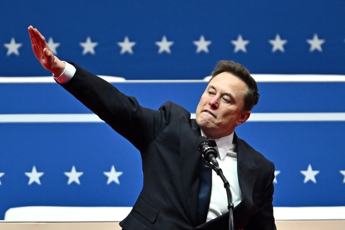 tesla-and-spacex-ceo-elon-musk-s-questionable-salute A man makes a salute.