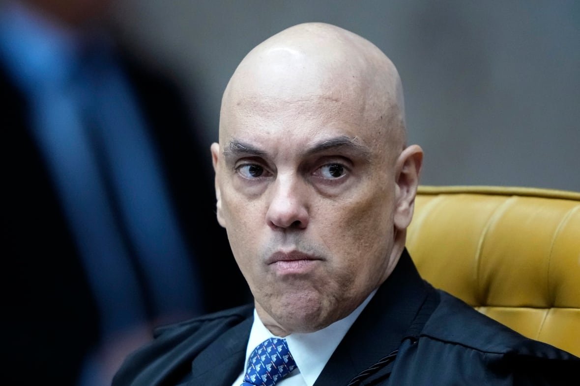brazil-supreme-court A person is seen pictured from the chest up as they sit in a chair.