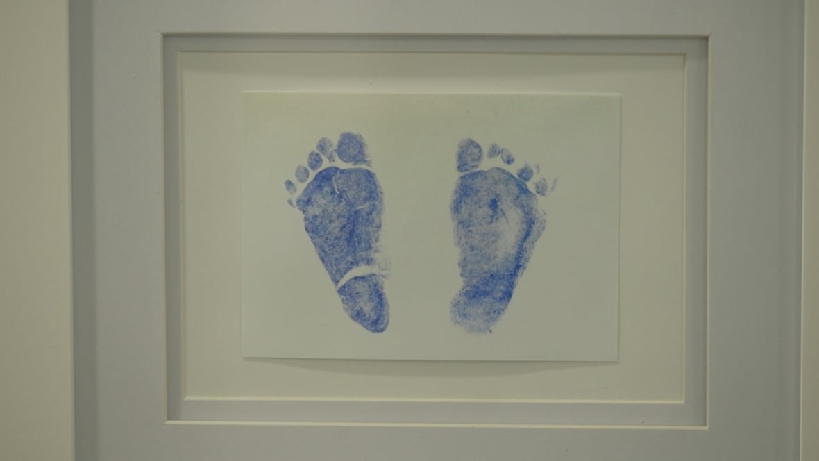 footprints A blue set of baby footprints in a white frame.