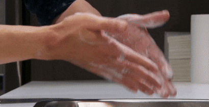 hand-washing close up of a person washing hands vigourously.
