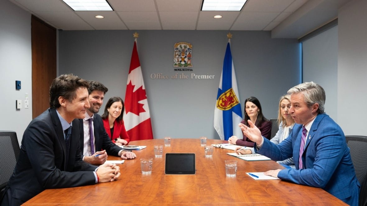 houston-december-9 A long table with the flags of Canada and Nova Scotia. Sitting down are six people in suits.