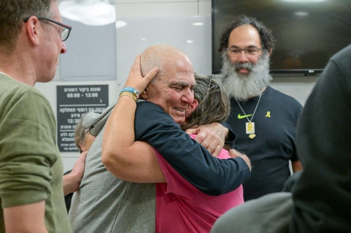 A man hugs a woman.