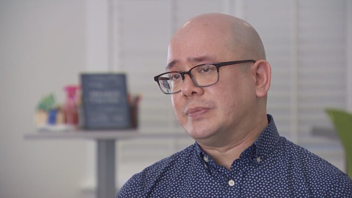 jonny-morris A bald man with glasses looks solemn.