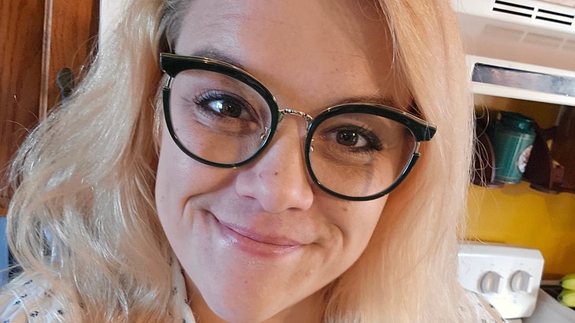 maggie-campbell A woman with blond hair and glasses smiles at the camera