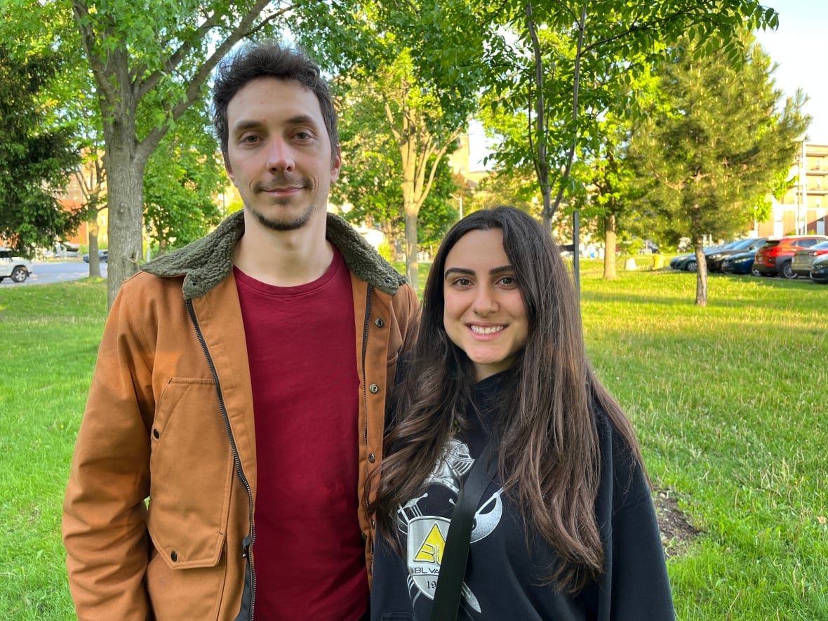 mikhael-esterez Two people a man and a young woman pose for a picture outside.