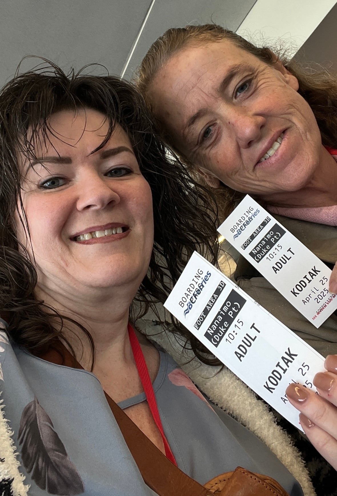 rachael-smith-taylor Two women photographed head-to-head show off their ferry boarding passes.