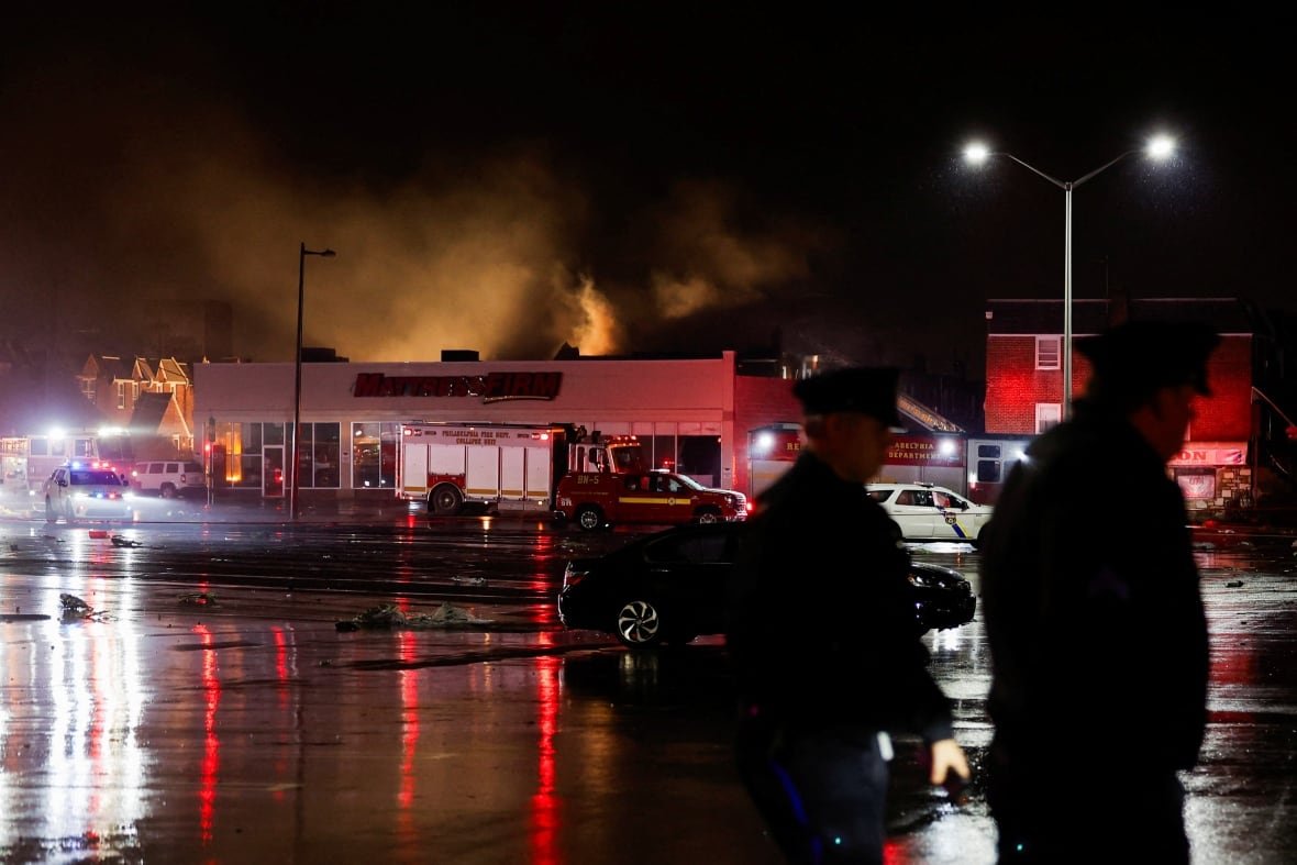 Smoke rises behind a building in Philadelphia.