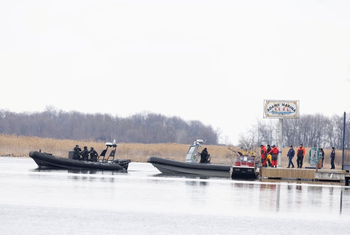 akwesasne-body-death-search-police Three police boats at and around a dock in early spring.