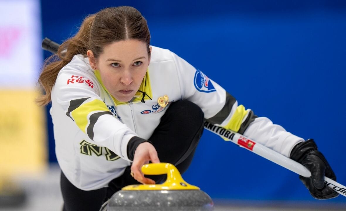 cur-tournament-of-hearts-20250215 A female curling skip delivers a rock with her right hand.