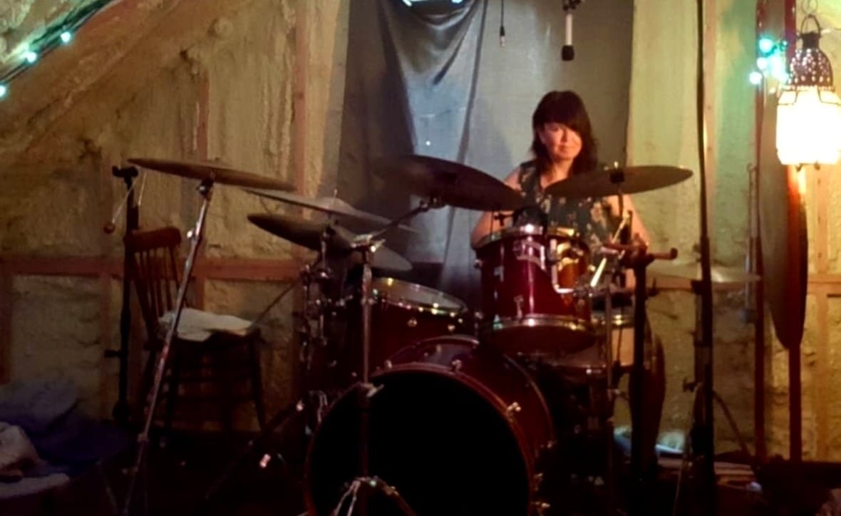 jennifer-lovegrove-drums A woman sitting behind a full drum kit