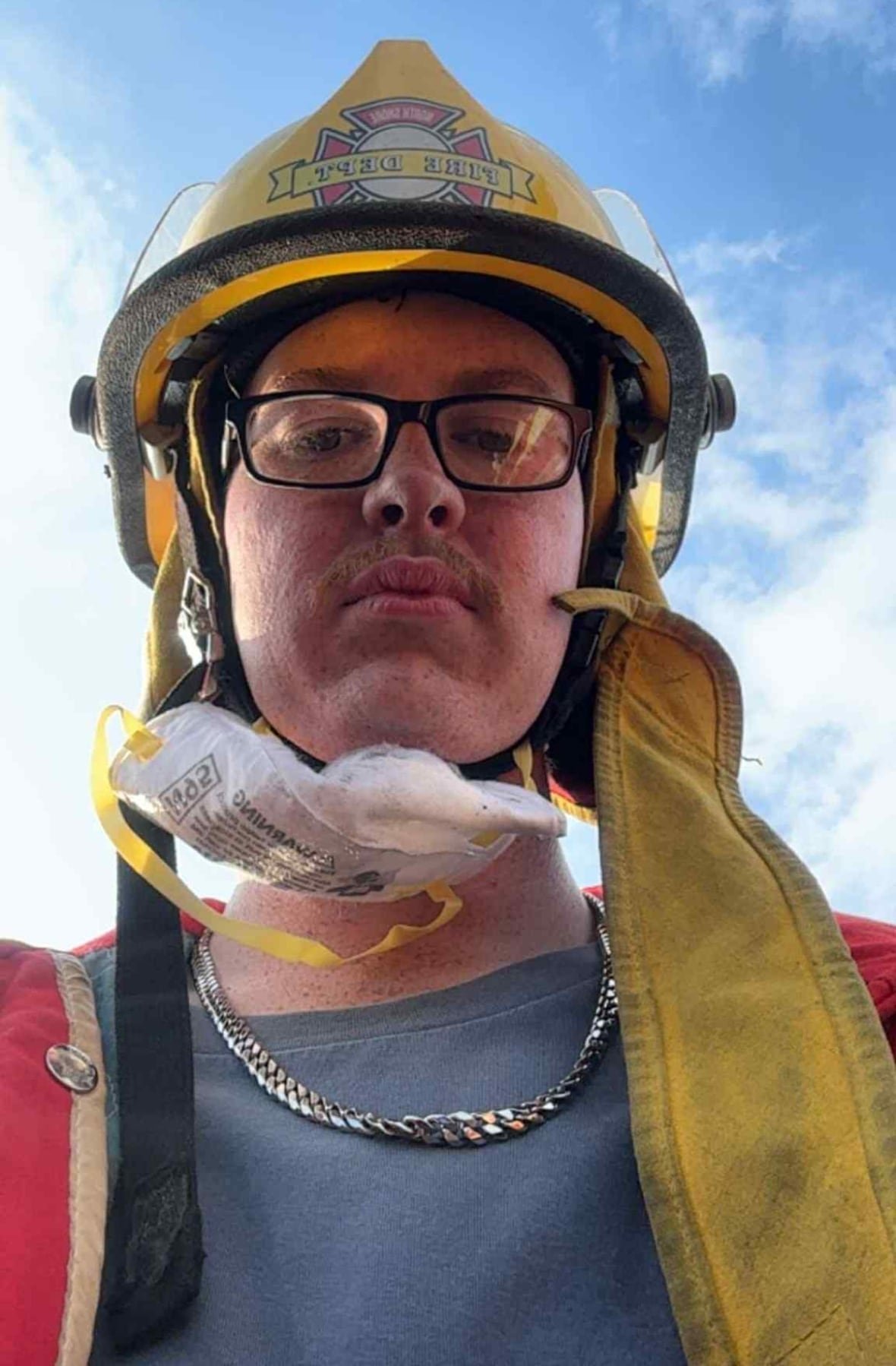landon-hatch Person in large yellow and mask hanging from face looking downwards