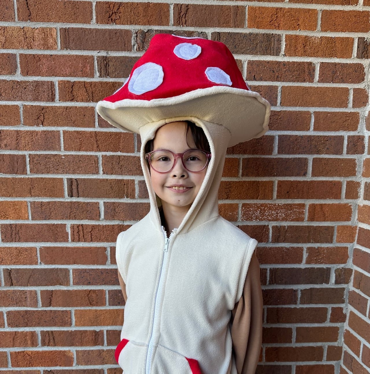 default-151 A young girl stands in a mushroom costume
