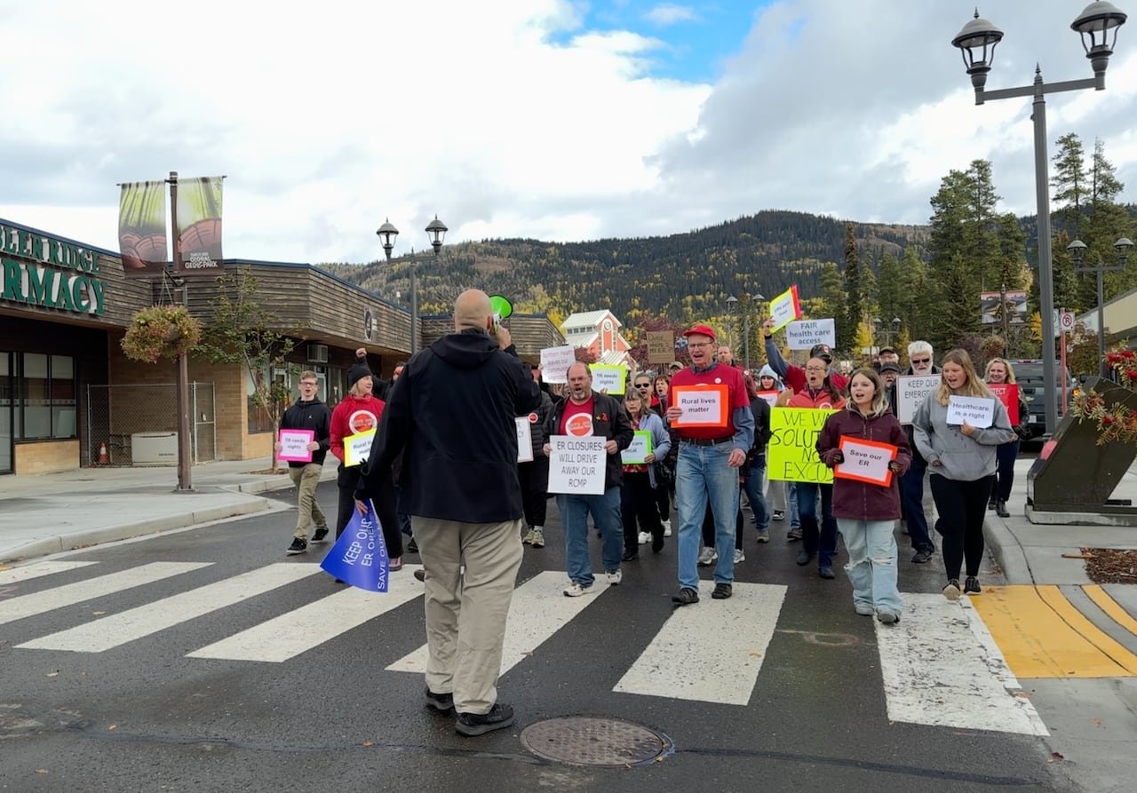 default-157 demonstrators holding signs protesting emergency room cuts walk through the streets of a small community